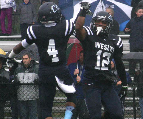 Sean Hopkins and Leon Jones celebrate Hopkins' first-quarter fumble return for a touchdown. (Wesley athletics photo)